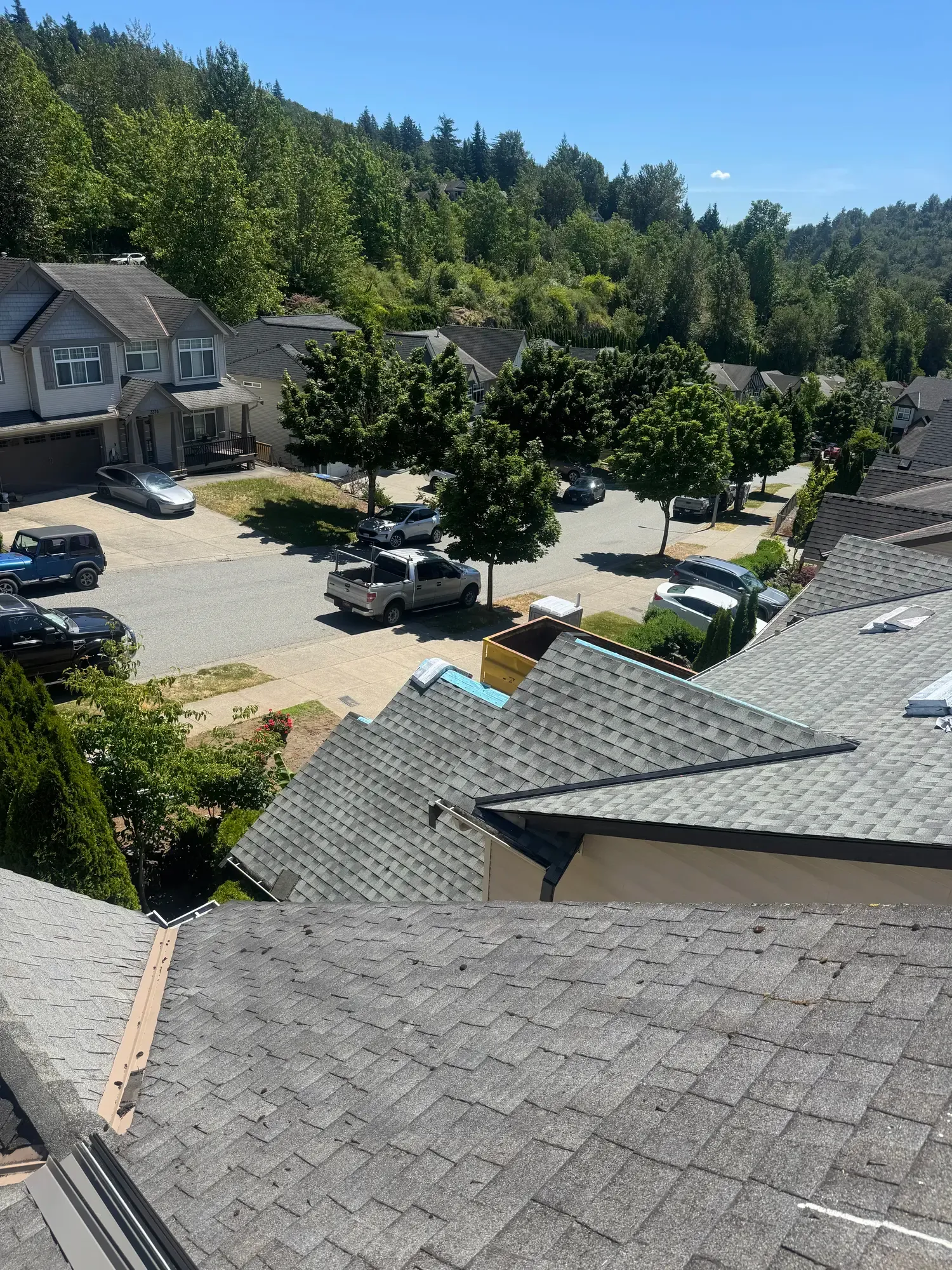Aerial view of a completed asphalt shingle roof by Raindeer Roofing in a Calgary neighbourhood